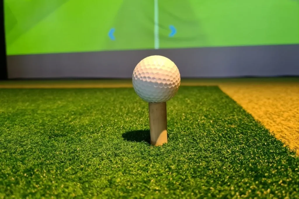 an image showing golf ball in front of a golf simulator