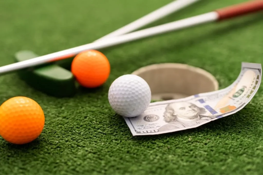 The image shows currency notes, a ball, and a golf club 