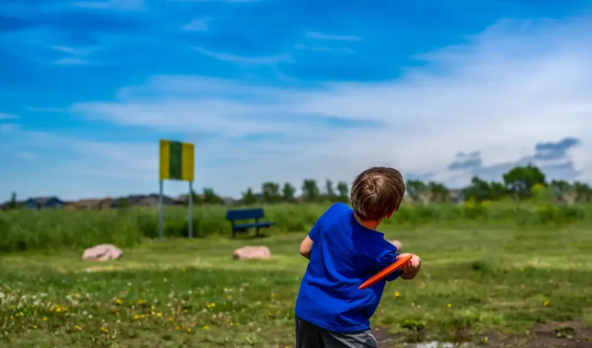 A child playing with disc golf